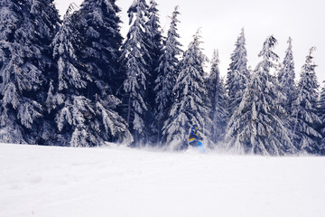 Snowboarder rides down during a blizzard