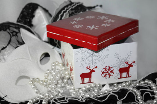 Winter red and white present box giftbox and lacy black and white background