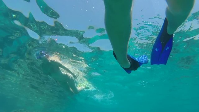 Young Couple Snorkeling In Beautiful Blue Ocean