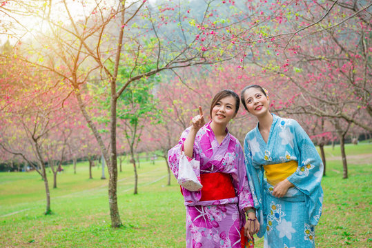 happy elegant girls wearing japanese kimono