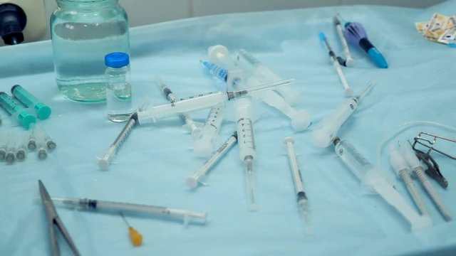 A tray full of syringes and jars with balanced salt solution. 