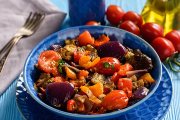 Oven baked vegetables salad - eggplants, tomatoes, sweet peppers and onion.