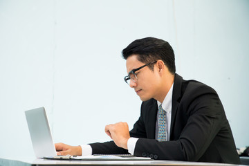 Business man working at office with laptop and documents on his desk