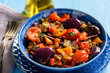 Oven baked vegetables salad - eggplants, tomatoes, sweet peppers and onion.