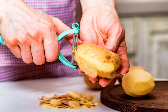 Hands Peeling Potatoes Close