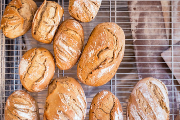 Freshly cooked organic french breads with white flour on it. Horizontal composition, top view