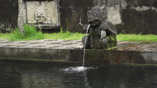 Hindu Balinese Water Palace Tirta Gangga with statues of the gods, fountains in the form of monkey on Bali island, Indonesia. Tirta Gangga the former royal water palace is a maze of pools and