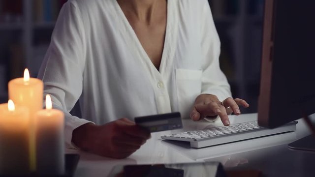 Woman doing online shopping at night