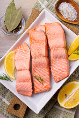 Boiled salmon on white plate. Poached salmon fillet. Good for health diet fish. View from above, top, horizontal