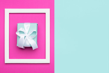 Happy Mother's Day, Women's Day, Valentine's Day or Birthday Pastel Blue and Pink Candy Colour Background. Flat lay minimal concept with beautifully wrapped present.