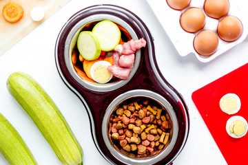petfood set with vegetables and eggs on kitchen table background