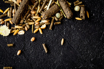 dry food for rodents on dark background top view