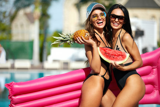Summer Fashion. Girls In Swimsuits Having Fun Near Pool
