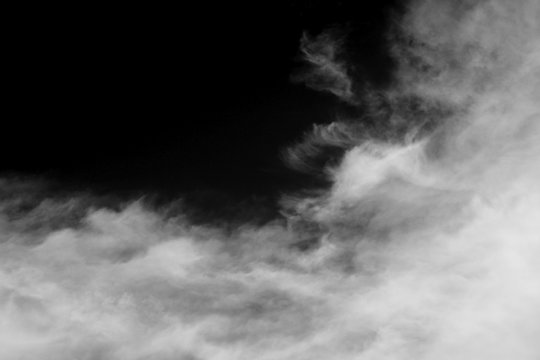 Clouds over black.