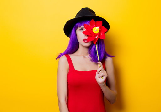 hipster girl with purple hairstyle with pinwheel