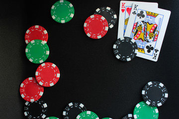 Poker set. Group of cards, dices and chips on black background. Top view, copy space