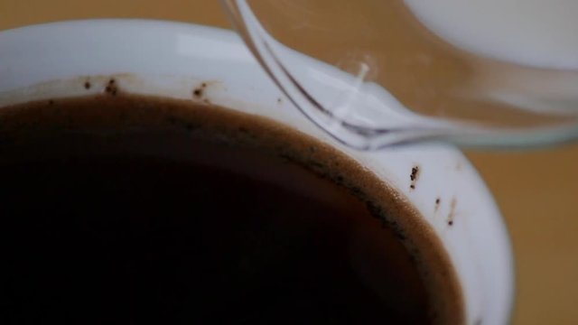 pouring milk into coffee close, slow