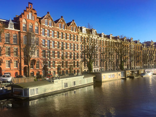 Naklejka premium houseboats on canal Amsterdam