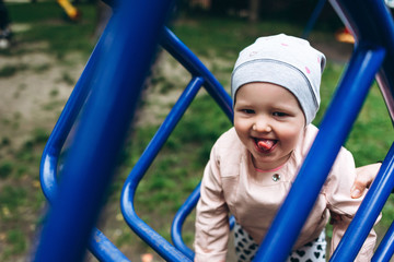 Two year old girl smiling and playing outside at playground