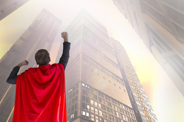 businessman dressed in a suit with a Cape superhero 