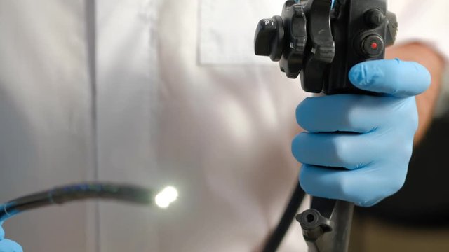 Doctor gastroenterologist with probe to perform gastroscopy and colonoscopy