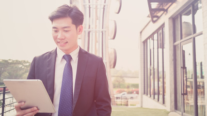 Fototapeta premium young asian business man have a happy time with his job, love working