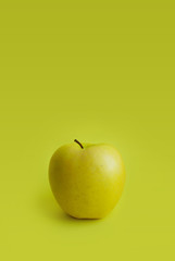 Perfect fresh green apple isolated on green-yellow background. Food creative concept. Art fruit photo.