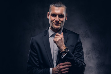 Fototapeta premium Handsome businessman against a dark background.