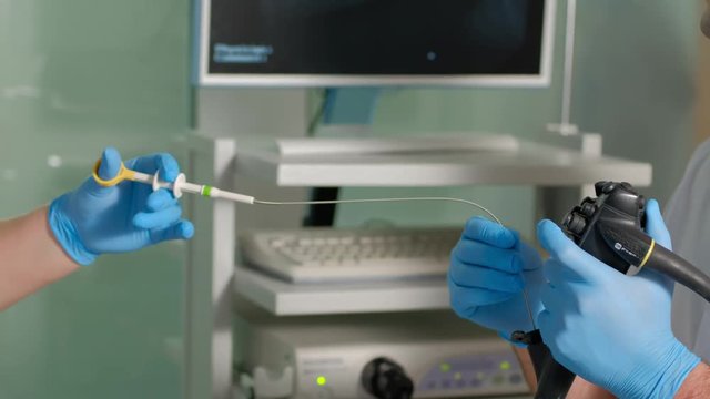 Doctor gastroenterologist and nurse with probe to perform gastroscopy and colonoscopy