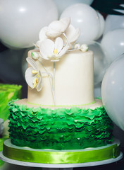 Fototapeta na wymiar green cake decorated with phalaenopsis flowers