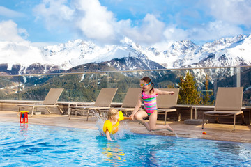 Kids in outdoor swimming pool of Alpine resort