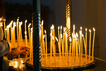 Lit candles in candlestick at church
