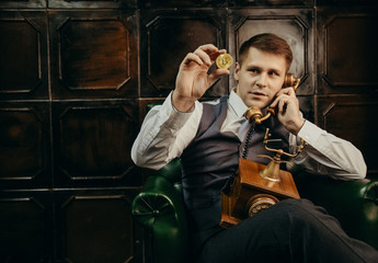 the younge man holding the bitcoin in the hand