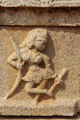 Stone bas-reliefs on the walls around the Vittala Temple in Hampi, Karnataka, India.