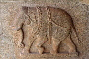 Stone bas-reliefs on the walls around the Vittala Temple in Hampi, Karnataka, India.