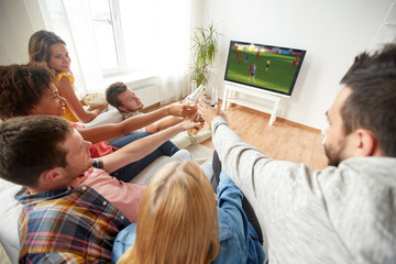 friends with beer watching football or soccer game