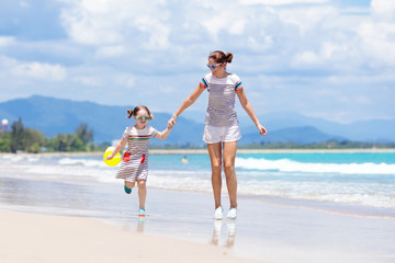 Naklejka premium Mother and child on tropical beach. Sea vacation