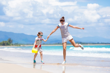 Mother and child on tropical beach. Sea vacation