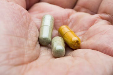 Herbal medicine capsules in hand