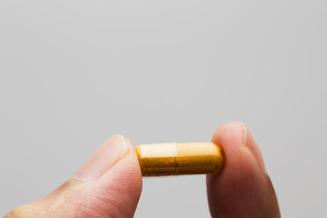 Hand grab Herbal medicine in capsule