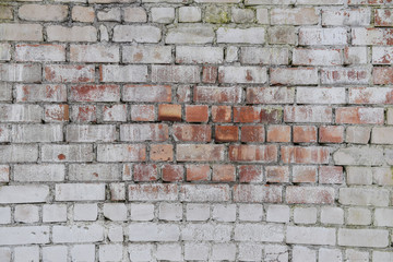 The wall of red brick is painted white