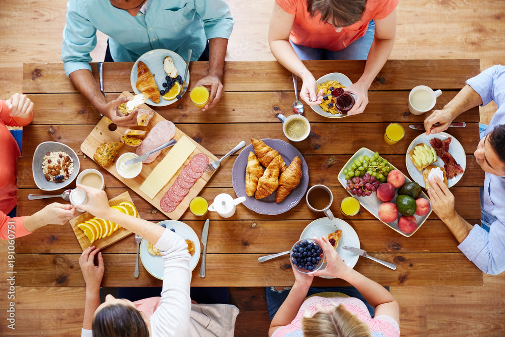 Wall mural group of people having breakfast at table