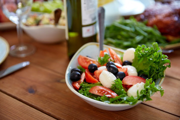 vegetable salad with mozzarella on wooden table
