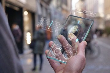A man in the city, use the transparent phone with the latest technology for video calls with holography family on vacation. Concept: technology, future and futuristic technology, family