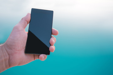 Using mobile phone by the swimming pool