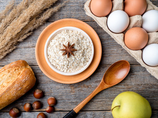 Ingredients for Breakfast Oatmeal Eggs Bread Apple Rustic Wooden background