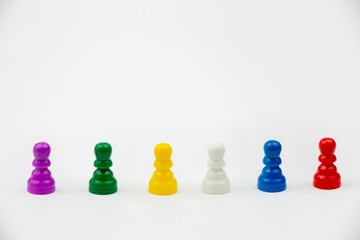 Board game with different colored game pawns on it. Ludo or Sorry board game play figures isolated on white background