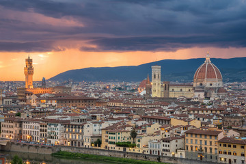 Fototapeta na wymiar Beautiful sunset and rain thunder storm over Cathedral of Santa Maria del Fiore (Duomo) and Vecchio palazzo, Florence, Italy