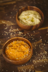 Hummus bowls. Chickpea hummus on wooden table.