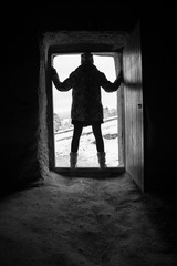 Horror Scene of a Woman Possessed with Blurry Head holding a doll at front door of an old house